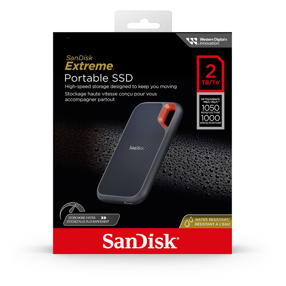 SanDisk Extreme tragbare externe SSD 2TB in Schwarz auf einem Tisch neben Laptop und Kamera für mobile Datenspeicherung